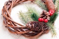 Christmas wreath of twigs with pine needles and cones on light b Royalty Free Stock Photo
