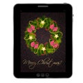 Christmas wreath on vintage background at tablet. Royalty Free Stock Photo