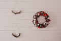Christmas wreath, vintage composition with red gift boxes on a white wooden background. Royalty Free Stock Photo