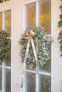 Christmas wreath on white doors close-up on the side. Winter fairy tale. Wonderful decoration Royalty Free Stock Photo