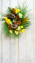 Christmas wreath with yellow fabric roses and golden pinecones Royalty Free Stock Photo