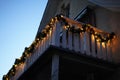 Christmas wreaths with candle lights on white wooden balcony