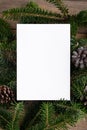 Christmas 5x7 card mockup template with fir twigs on wooden background. Design element for Christmas and New Year Royalty Free Stock Photo