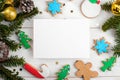 Christmas 7x5 card mockup template with with Christmas gingerbread cookies fir twigs on white wooden background Royalty Free Stock Photo