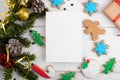 Christmas 5x7 card mockup template with with Christmas gingerbread cookies fir twigs on white wooden background Royalty Free Stock Photo