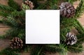 Christmas 5x5 card mockup template on natural fir twigs on wooden background. Design element for Christma Royalty Free Stock Photo