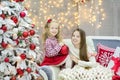 Christmas xmas casual gold studio decorations with cute girl and huge mirror with golden frame plenty presents and big green pine Royalty Free Stock Photo