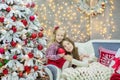 Christmas xmas casual gold studio decorations with cute girl and huge mirror with golden frame plenty presents and big green pine Royalty Free Stock Photo