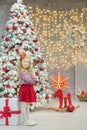 Christmas xmas casual gold studio decorations with cute girl and huge mirror with golden frame plenty presents and big green pine