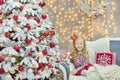 Christmas xmas casual gold studio decorations with cute girl and huge mirror with golden frame plenty presents and big green pine