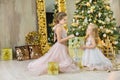 Christmas xmas casual gold studio decorations with cute girl and huge mirror with golden frame plenty presents and big green pine