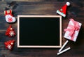 Christmas Xmas New Year holiday background with empty black chalkboard for your text and various festive decorations. blank chalk Royalty Free Stock Photo