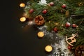 Christmas. Xmas toys, burning candles and spruce branch on black background top view. Space for text Royalty Free Stock Photo