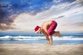 Christmas yoga on the beach Royalty Free Stock Photo