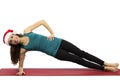 Christmas yoga woman in side plank pose Royalty Free Stock Photo