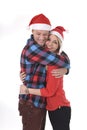 Christmas young beautiful couple in Santa hats in love smiling happy together hugging each other sweet Royalty Free Stock Photo