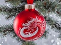 For Christmas yuki hangs a red balloon with a dragon on it. Christmas glass ball on the tree, generated AI