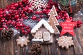 Christmass New Year decorations. Hollly berries, sweet Christmas gingerbread cookies in shape of house and Christmas trees on Royalty Free Stock Photo