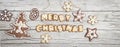 Christmassy grey wood background with gingerbread and Merry Christma`s letter