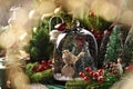 Christmas decoration with a bird figurine and trees inside of glass bell Royalty Free Stock Photo