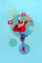 Christmastime sale collage of young woman jumping makes shot selfie blogger shopaholic winter holidays isolated on blue Royalty Free Stock Photo