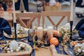 Christmastime table setting, festive dinnerware decorated with pretty details and candles in Blue and Gold colors. Navy Blue Table Royalty Free Stock Photo