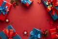 Christms, party concept. Blue and red gift boxes with red ribbon and bow isolated on red background, top view Royalty Free Stock Photo