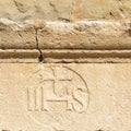 Christogram IHS monogram symbolizing Jesus Christ on stone wall