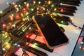 Chritmas balls and gift boxes on classical piano keyboard, smartphone Royalty Free Stock Photo