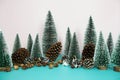 Christmas and happy new year holidays background with Christmas trees and pine cone on pink and blue background Royalty Free Stock Photo