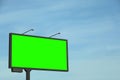 Chroma key compositing. Big empty billboard with green screen against blue sky. Mockup for design Royalty Free Stock Photo