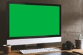 Chroma key green screen, angled view computer on table with digital photography equipment