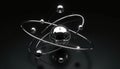 Chrome atom model with orbiting electrons in a dark background. Illustrates scientific concept of atomic structure and subatomic Royalty Free Stock Photo