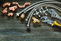 Chrome and copper plumbing accessories on vintage wood Royalty Free Stock Photo