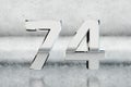 Chrome 3d number 74. Glossy chrome number on scratched metal background. 3d render