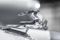 Chromed figure of a galloping deer in profile