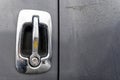 Chrome door handle with lock on the door of a gray wet big rig semi truck Royalty Free Stock Photo