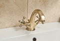 Chrome dripping tap. Sink faucet in bathroom. Water saving concept. Closeup of water-supply faucet mixer for water