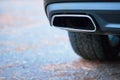 Chrome exhaust pipe selective focus of powerful luxury car with black bodywork as part of exhaust system car muffler of Royalty Free Stock Photo