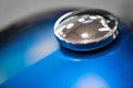 Chrome gas tank cap on blue motorcycle Royalty Free Stock Photo