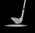 Chrome Golf Club Wedge Iron Under Spot Light With Black Background