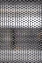 Chrome grid with round holes over a gray background, copy space Royalty Free Stock Photo