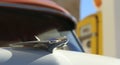 A Chrome Hood Ornament on a Vintage Car