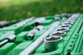 Chrome mechanics tools set. Close-up photo of a set of sockets with a screwdriver and a ratchet in a green plastic case against a Royalty Free Stock Photo