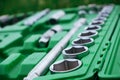 Chrome mechanics tools set. Close-up photo of a set of sockets with a screwdriver and a ratchet in a green plastic case against a Royalty Free Stock Photo