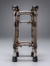 Folded metallic mobility walker standing upright on neutral gray background studio lighting Royalty Free Stock Photo