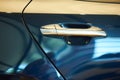Chrome metallic handle of new blue car Royalty Free Stock Photo