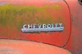 Chrome nameplate on the side of a 1951 Chevy pickup truck in a junkyard in Idaho, USA - July 26, 2021 Royalty Free Stock Photo