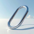 Chrome Oval Ring Shape Object on White Surface Against Blue Sky and Clouds Royalty Free Stock Photo