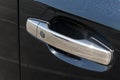 The chrome-plated door handle of a modern black car. Close-up car detail Royalty Free Stock Photo
